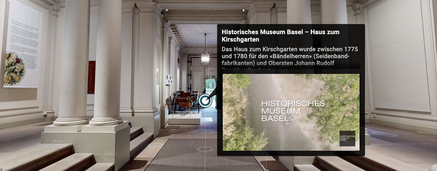 An elegant corridor with columns and display boards invites virtual exploration.