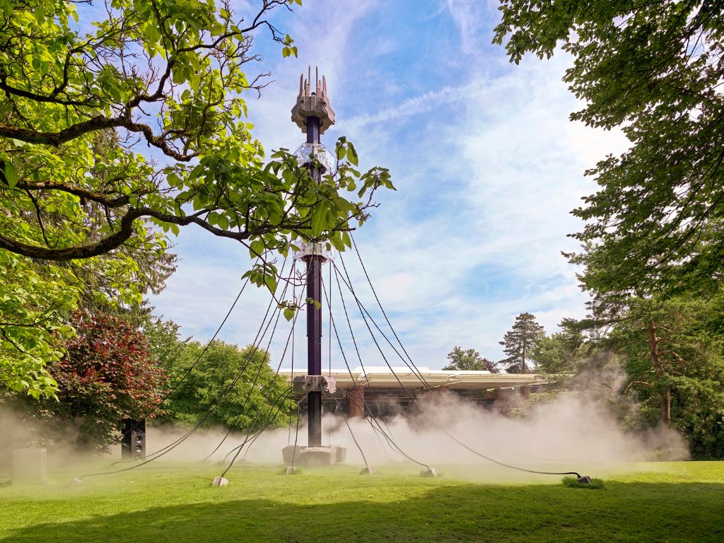 Tower with lights in the foggy park at Fondation Beyeler